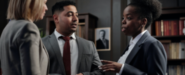 3 people in suits discussing